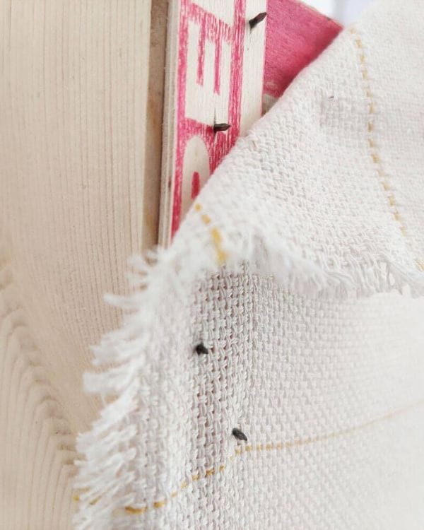 lining up tufting cloth using guides 